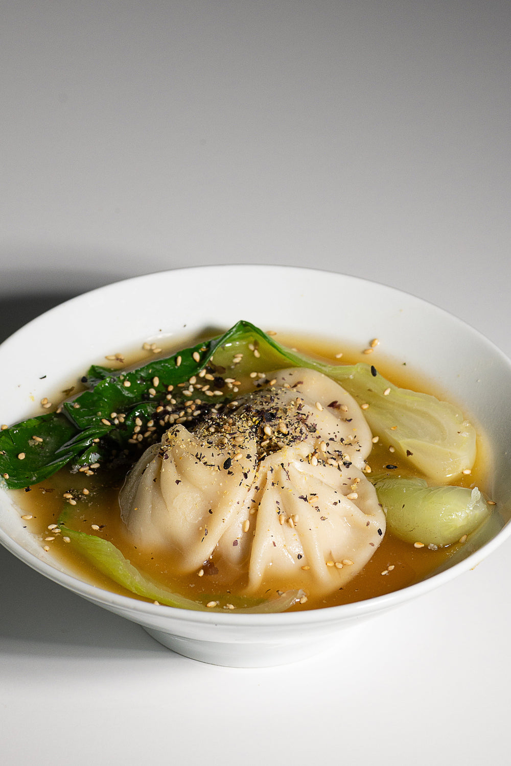Dumplings and bok choy in miso broth with Essential Furikake