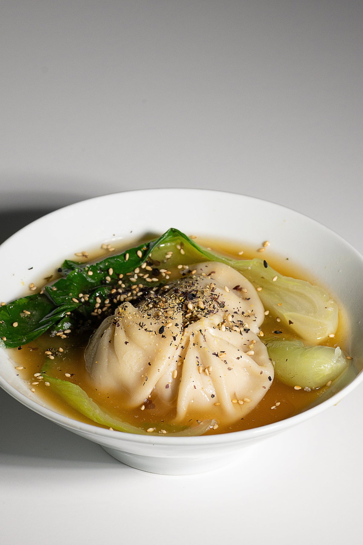 Dumplings and bok choy in miso broth with Essential Furikake